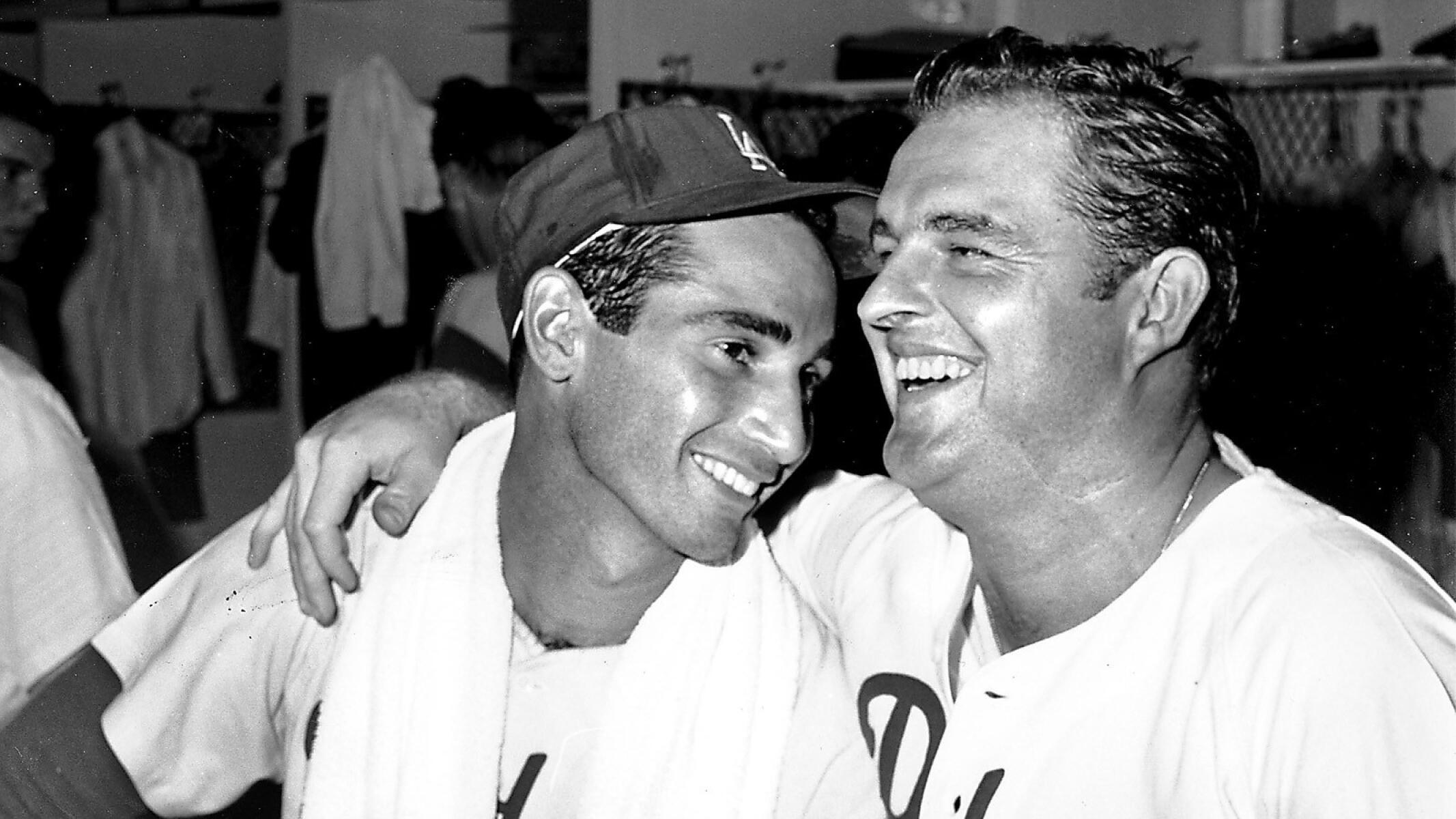Baseball pitchers Don Drysdale (53) and Sandy Koufax share a laugh in the dressing room at Dodger Stadium.